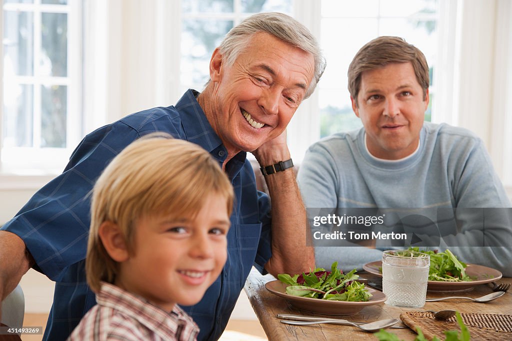Two men and young boy at dining room table