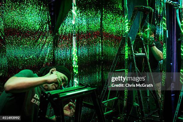 Staff members work to repair lines of LED lights prior to the start of a show at The Robot Restaurant on June 29, 2014 in Tokyo, Japan. The now...