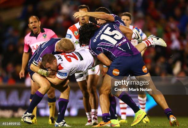 Trent Merrin of the Dragons is up ended during the round 16 NRL match between the St George Illawarra Dragons and the Melbourne Storm at WIN Stadium...