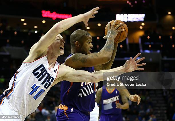 Tucker of the Phoenix Suns keeps the ball away from Cody Zeller of the Charlotte Bobcats during their game at Time Warner Cable Arena on November 22,...