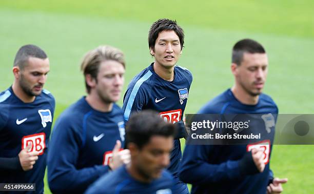 Genki Haraguchi of Hertha BSC jogs during the first Hertha BSC Berlin team training session at Stadion am Wurfplatz on June 30, 2014 in Berlin,...