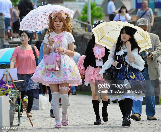 The event participants in Lolita fashion costumes walk along the canal on June 29, 2014 in Otaru, Hokkaido, Japan. About 90 girls and young women...
