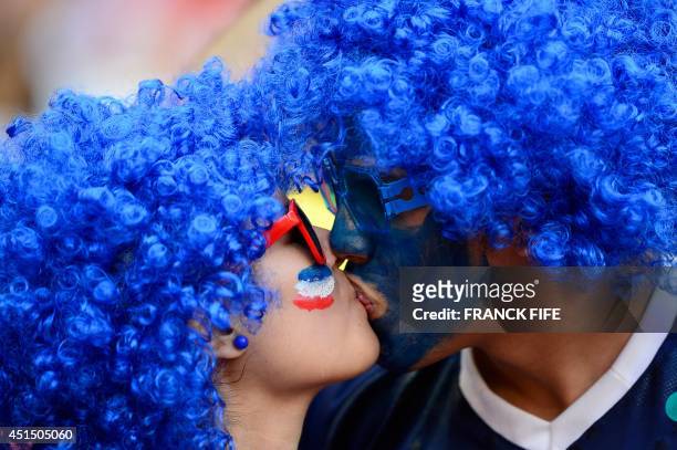 French fans kiss before the round of 16 football match between France and Nigeria at the Mane Garrincha National Stadium in Brasilia during the 2014...