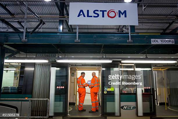 Alstom employees stand aboard a Citadis tram, manufactured by Alstom SA, during routine maintenance at the Nottingham Express Transit Wilkinson...