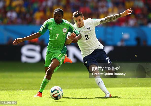 Ahmed Musa of Nigeria competes for the ball with Mathieu Debuchy of France during the 2014 FIFA World Cup Brazil Round of 16 match between France and...