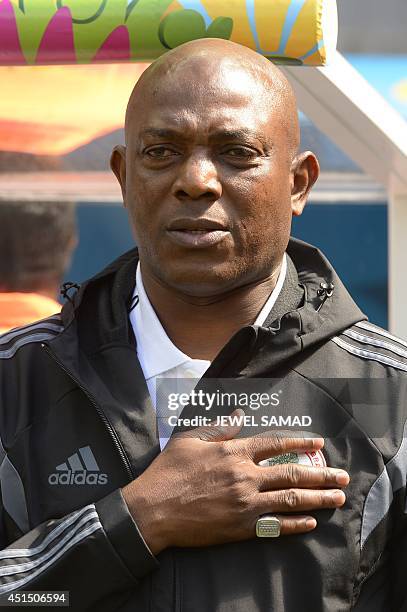 Nigeria's coach Stephen Keshi sings his national anthem during a Round of 16 football match between France and Nigeria at Mane Garrincha National...