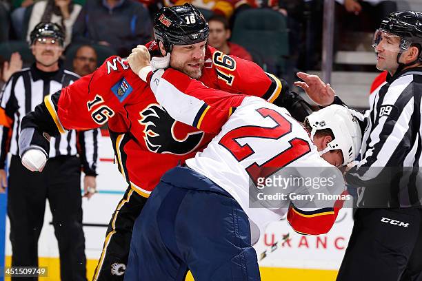 Brian McGrattan of the Calgary Flames fights Krys Barch of the Florida Panthers at Scotiabank Saddledome on November 22, 2013 in Calgary, Alberta,...