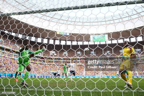 Victor Moses of Nigeria clears the ball off the goal line from a shot by Karim Benzema of France as goalkeeper Vincent Enyeama looks on during the...