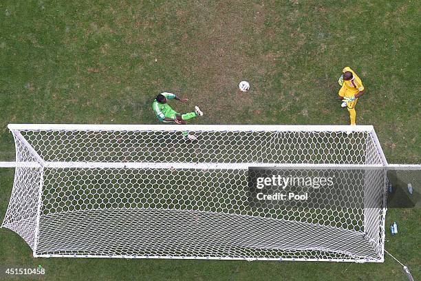 Victor Moses of Nigeria clears the ball off the goal line from a shot by Karim Benzema of France as goalkeeper Vincent Enyeama looks on during the...
