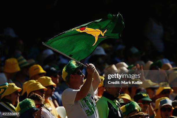 Spectator in the crowd waves a boxing kangaroo flag during day three of the First Ashes Test match between Australia and England at The Gabba on...