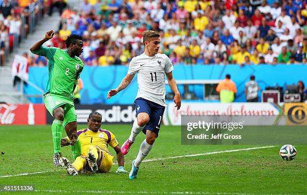 Joseph Yobo of Nigeria scores an own goal as goalkeeper Vincent Enyeama and Antoine Griezmann of France look on during the 2014 FIFA World Cup Brazil...