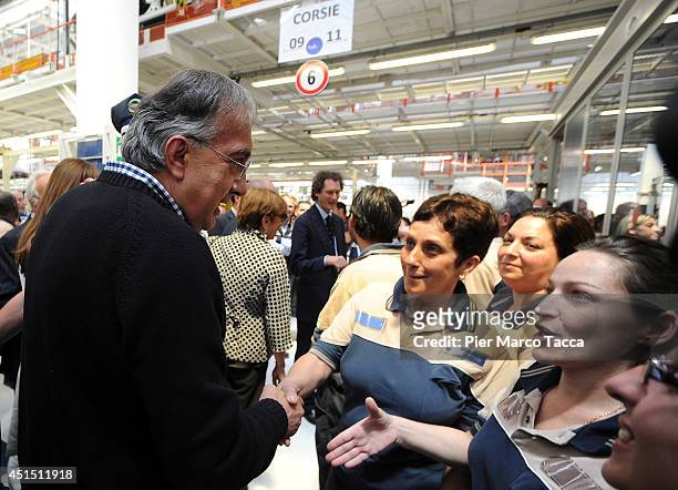 Fiat Chrysler Automobiles Group Chief Executive Officer Sergio Marchionne greets workers during the visit of the Maserati Factory in Grugliasco...