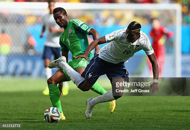 John Obi Mikel of Nigeria challenges Paul Pogba of France during the 2014 FIFA World Cup Brazil Round of 16 match between France and Nigeria at...