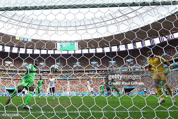 Victor Moses of Nigeria clears the ball off the goal line from a shot by Karim Benzema of France as goalkeeper Vincent Enyeama looks on during the...