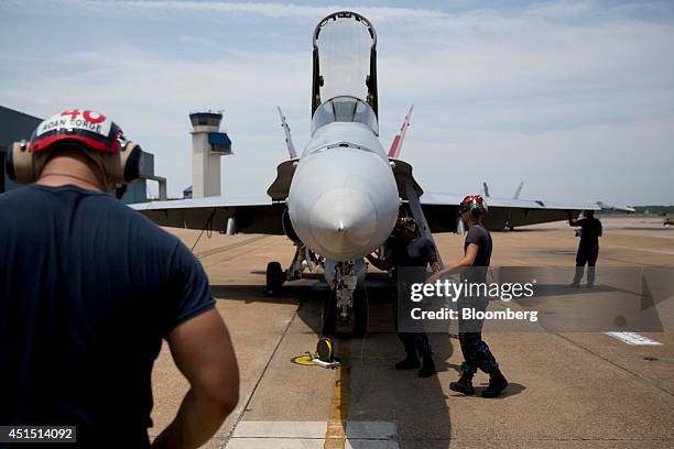 Members of the U.S. Navy Strike Fighter Squadron "Wildcats" perform maintenance on an F/A-18C aircraft after a flight at the Naval Air Station Oceana...