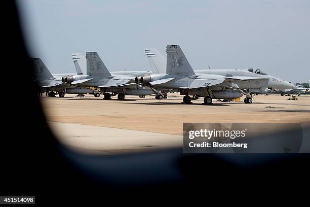 Navy F/A-18 aircraft sit on the flight line at the Naval Air Station Oceana in Virginia Beach, U.S., on Thursday, June 19, 2014. NAS Oceana is the...