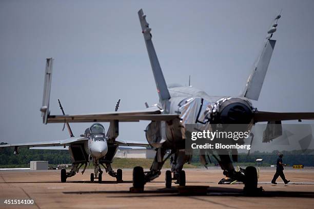 Boeing Co. F/A-18E Super Hornet aircraft, left, sits on the flight line at the Naval Air Station Oceana in Virginia Beach, U.S., on Thursday, June...