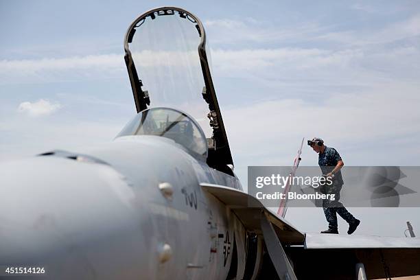 Navy petty officer 3rd class Jefferson Metzen performs maintenance on an F/A-18C aircraft after flight at the Naval Air Station Oceana in Virginia...