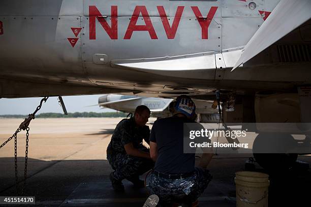Members of the U.S. Navy Strike Fighter Squadron "Wildcats" perform maintenance on an F/A-18C aircraft after a flight at the Naval Air Station Oceana...