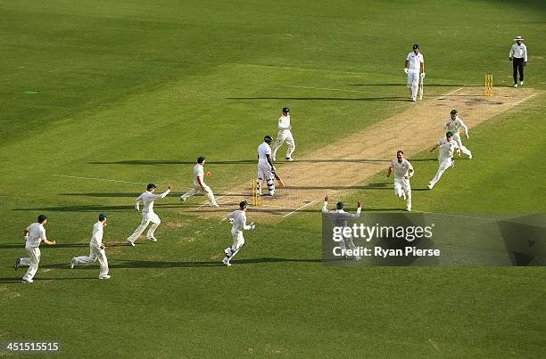 Ryan Harris of Australia celebrates after taking the wicket of Michael Carberry of England during day three of the First Ashes Test match between...