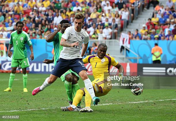 Joseph Yobo of Nigeria scores an own goal under pressure of Antoine Griezmann of France as Goalkeeper of Nigeria Vincent Enyeama looks on during the...