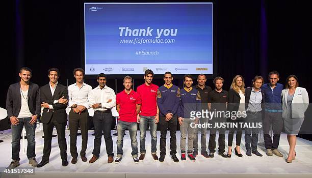 Team drivers pose together on stage at the Global Launch of the all-electric FIA Formula E Championship in London on June 30, 2014. AFP PHOTO/JUSTIN...