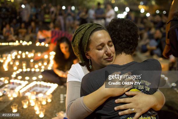 Israelis mourns and light candles in Rabin Square in Tel Aviv on June 30, 2014 after the announce that the bodies of the three missing Israeli...