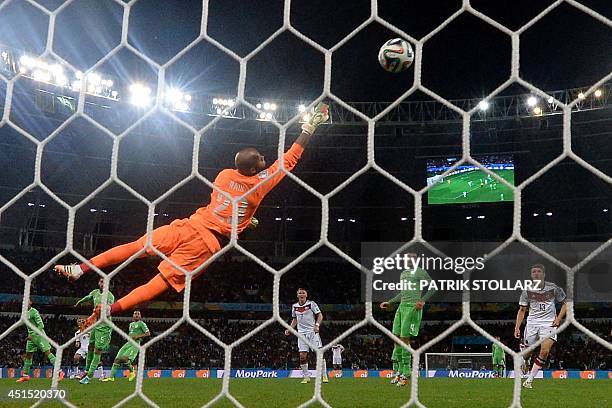 Algeria's goalkeeper Rais Mbohli makes a save during a Round of 16 football match between Germany and Algeria at Beira-Rio Stadium in Porto Alegre...