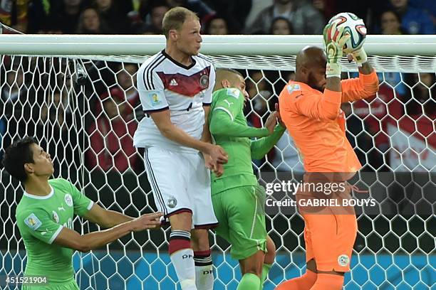 Algeria's goalkeeper Rais Mbohli saves the ball during the Round of 16 football match between Germany and Algeria at Beira-Rio Stadium in Porto...