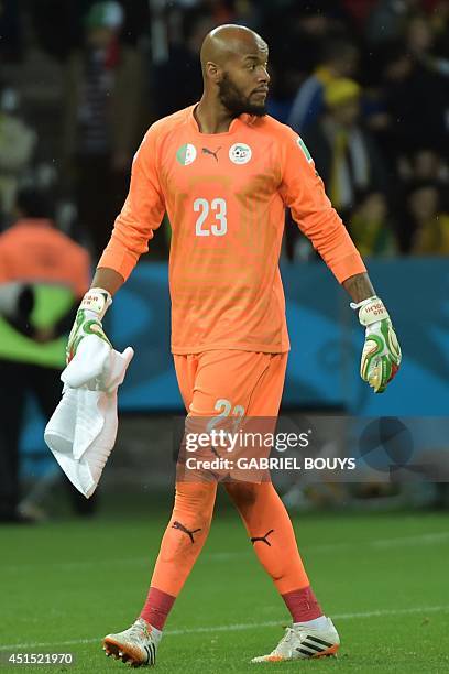 Algeria's goalkeeper Rais Mbohli walks on the pitch for the first half of extra-time in the Round of 16 football match between Germany and Algeria at...