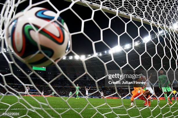 Rais M'Bolhi of Algeria fails to save a shot by Andre Schuerrle of Germany for Germany's first goal in extra time during the 2014 FIFA World Cup...