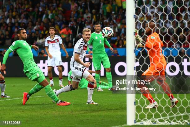 Andre Schuerrle of Germany scores his team's first goal past goalkeeper Rais M'Bolhi of Algeria in extra time during the 2014 FIFA World Cup Brazil...