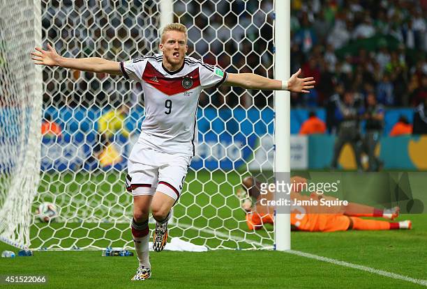 Andre Schuerrle of Germany celebrates scoring his team's first goal past goalkeeper Rais M'Bolhi of Algeria during the 2014 FIFA World Cup Brazil...