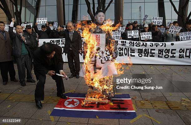 South Korean conservative protesters burn an effigy of North Korean leader Kim Jong-Un and a North Korean flag during an anti-North rally...