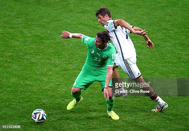 Mehdi Mostefa of Algeria controls the ball against Thomas Mueller of Germany during the 2014 FIFA World Cup Brazil Round of 16 match between Germany...