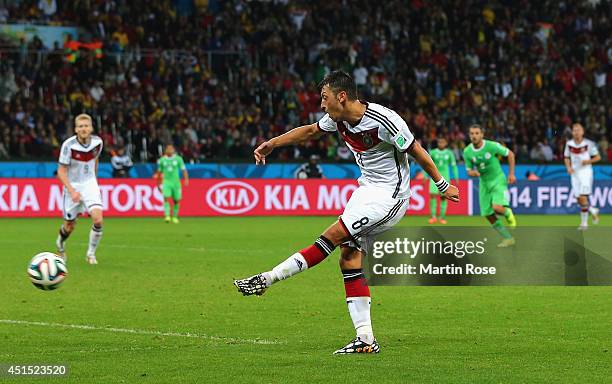 Mesut Oezil of Germany scores his team's second goal in extra time during the 2014 FIFA World Cup Brazil Round of 16 match between Germany and...