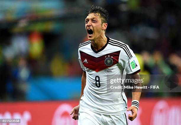 Mesut Oezil of Germany celebrates scoring his team's second goal during the 2014 FIFA World Cup Brazil Round of 16 match between Germany and Algeria...