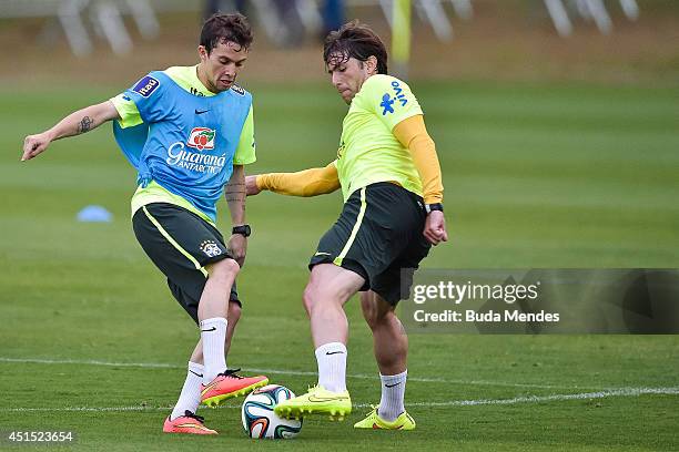 Bernard and Maxwell take part during a training session of the Brazilian national football team at the squad's Granja Comary training complex, on...
