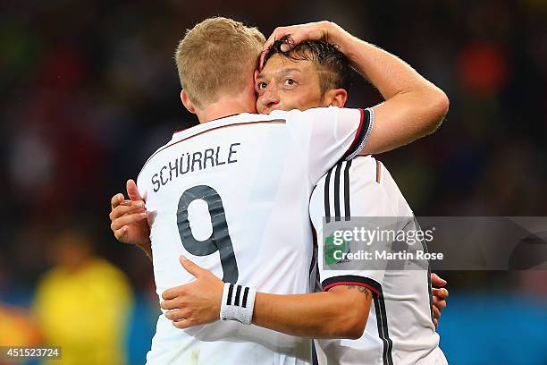 Mesut Oezil of Germany celebrates scoring his team's second goal in extra time with Andre Schuerrle during the 2014 FIFA World Cup Brazil Round of 16...