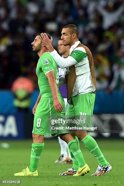 Dejected Medhi Lacen and Nabil Bentaleb of Algeria look on after being defeated by Germany 2-1 during the 2014 FIFA World Cup Brazil Round of 16...