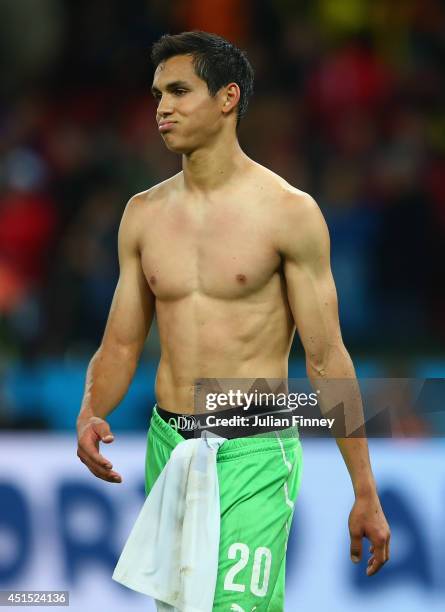 Dejected Aissa Mandi of Algeria looks on after being defeated by Germany 2-1 during the 2014 FIFA World Cup Brazil Round of 16 match between Germany...