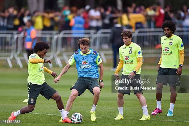 William, Henrique, Maxwell and Dante take part during a training session of the Brazilian national football team at the squad's Granja Comary...