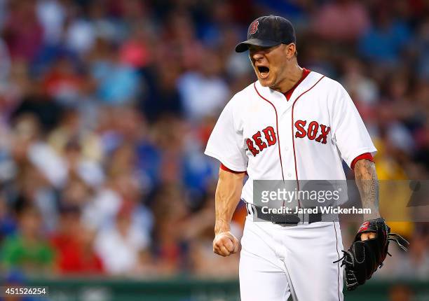 Jake Peavy of the Boston Red Sox reacts after giving up a two-run home run in the fourth inning against the Chicago Cubs during the interleague game...