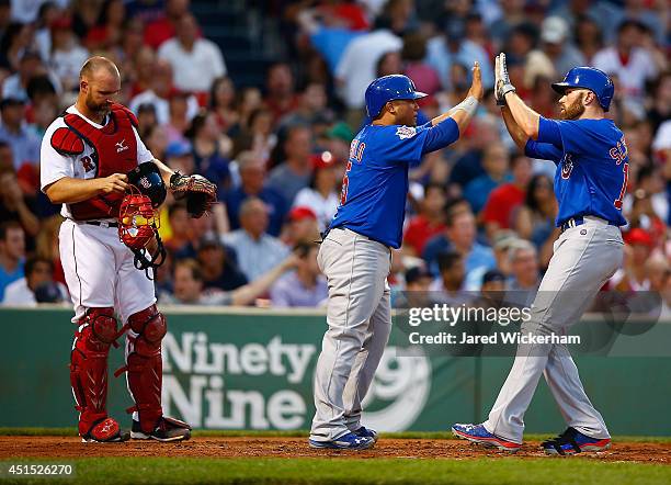 Nate Schierholtz of the Chicago Cubs is congratulated by teammate Welington Castillo after hitting a two-run home run in the fourth inning against...