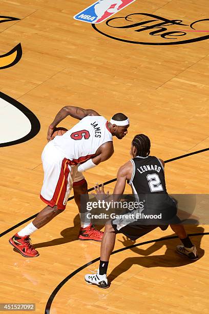 LeBron James of the Miami Heat controls the ball against Kawhi Leonard of the San Antonio Spurs during Game Three of the 2014 NBA Finals at American...