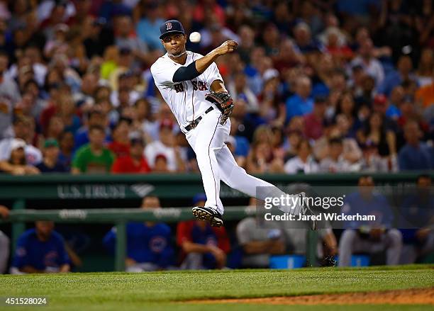 Xander Bogaerts of the Boston Red Sox throws a bare-handed ground ball to first base for the third out in the top of the seventh inning against the...