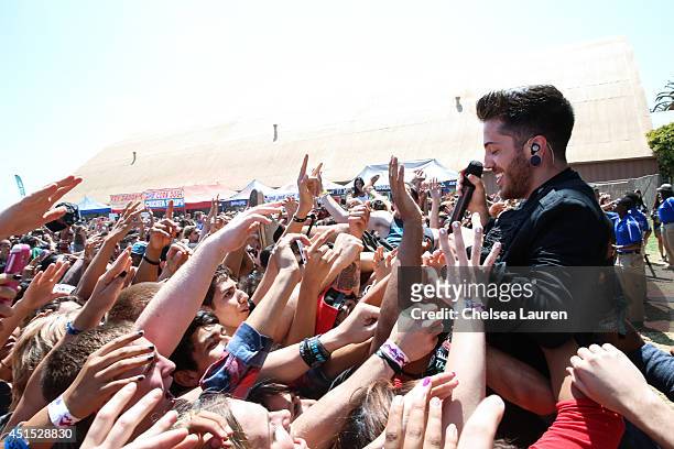 Vocalist David Escamilla of Crown the Empire performs during the Vans Warped Tour on June 22, 2014 in Ventura, California.