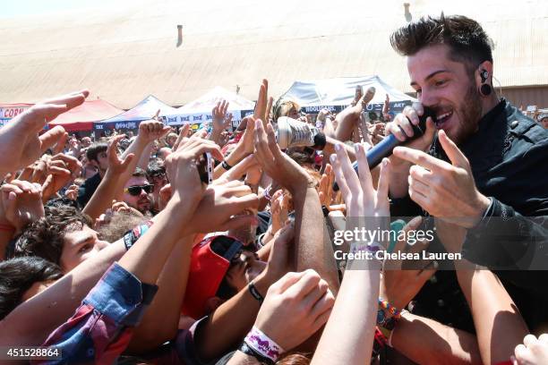 Vocalist David Escamilla of Crown the Empire performs during the Vans Warped Tour on June 22, 2014 in Ventura, California.