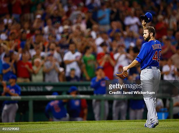 Jake Arrieta of the Chicago Cubs walks back to the dugout after being pulled for giving up his one and only hit in the eighth inning to Stephen Drew...