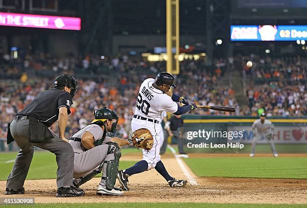 Rajai Davis of the Detroit Tigers hits a ninth-inning grand slam to win the game over the Oakland Athletics at Comerica Park on June 30, 2014 in...